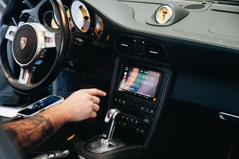 Touchscreen head unit installed in a Porsche 911 dash at FRQNCY Woods Cross