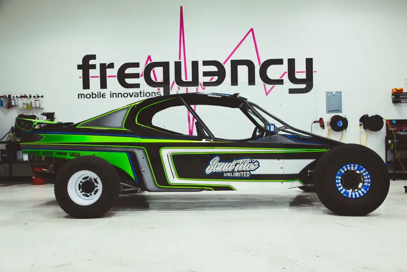 Custom wrapped sand car with graphics in the FRQNCY shop